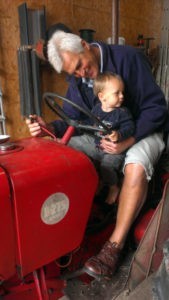 grandpa with his grandson on a tractor