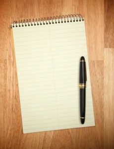 notebook with a pen