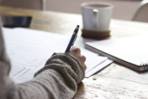 Woman's hand, writing at a table