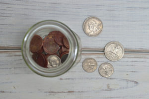 Coins in a jar on a table