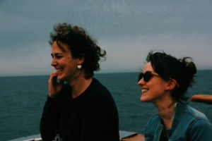 Two women on a boat overlooking sea
