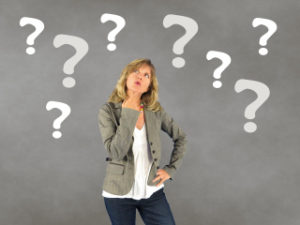 Woman standing under Question Marks