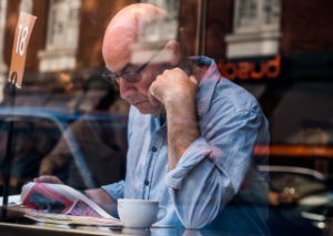 man reading over coffee