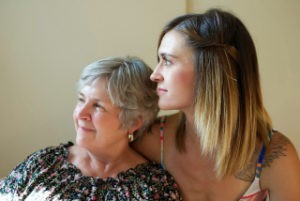 A younger woman hugging an older woman