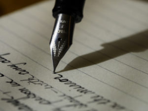 pen writing in journal