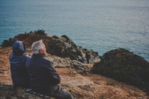 An old couple staring at ocean