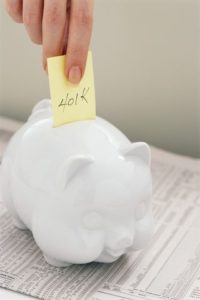 Post with "401k' on it going into piggy bank