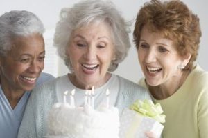 three senior females celebrating a bday