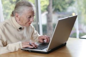elderly money on laptop