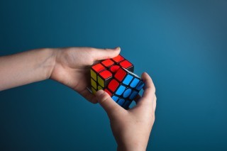 a person solving a rubik's cube