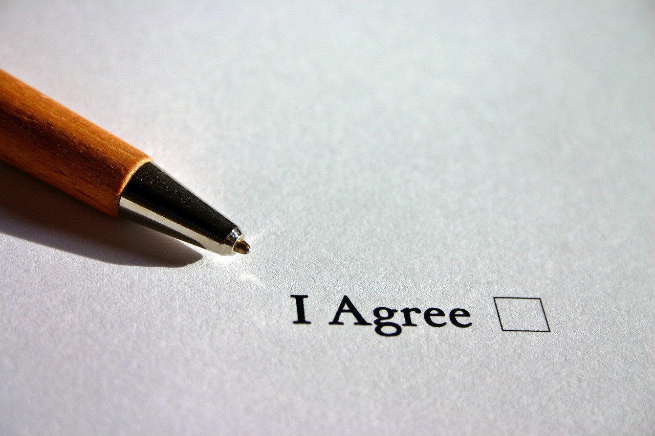 Pen with an "i agree" box on a document