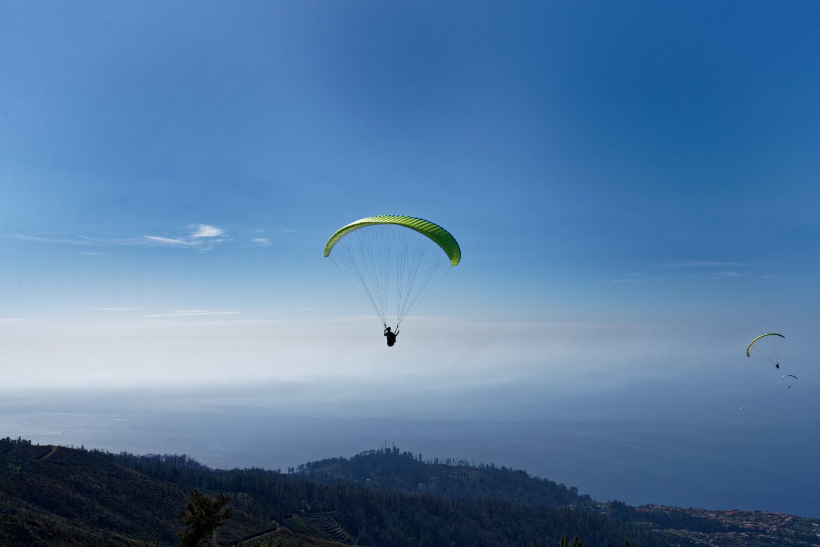 person parasailing over mountains