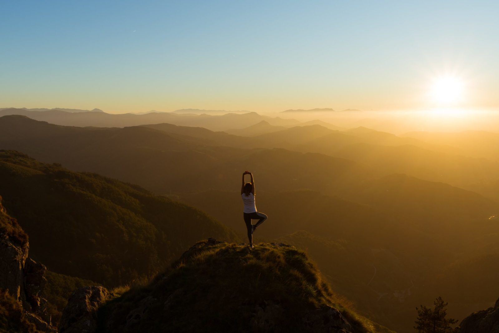 woman doing yoga on a mountain