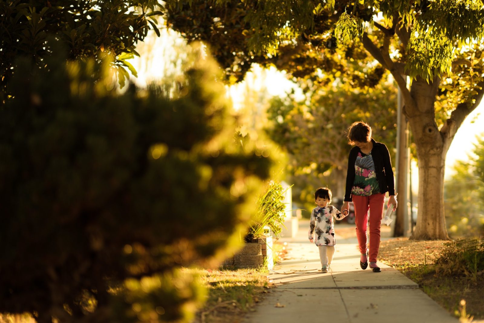 grandmother and daughter walking down the sidewalk