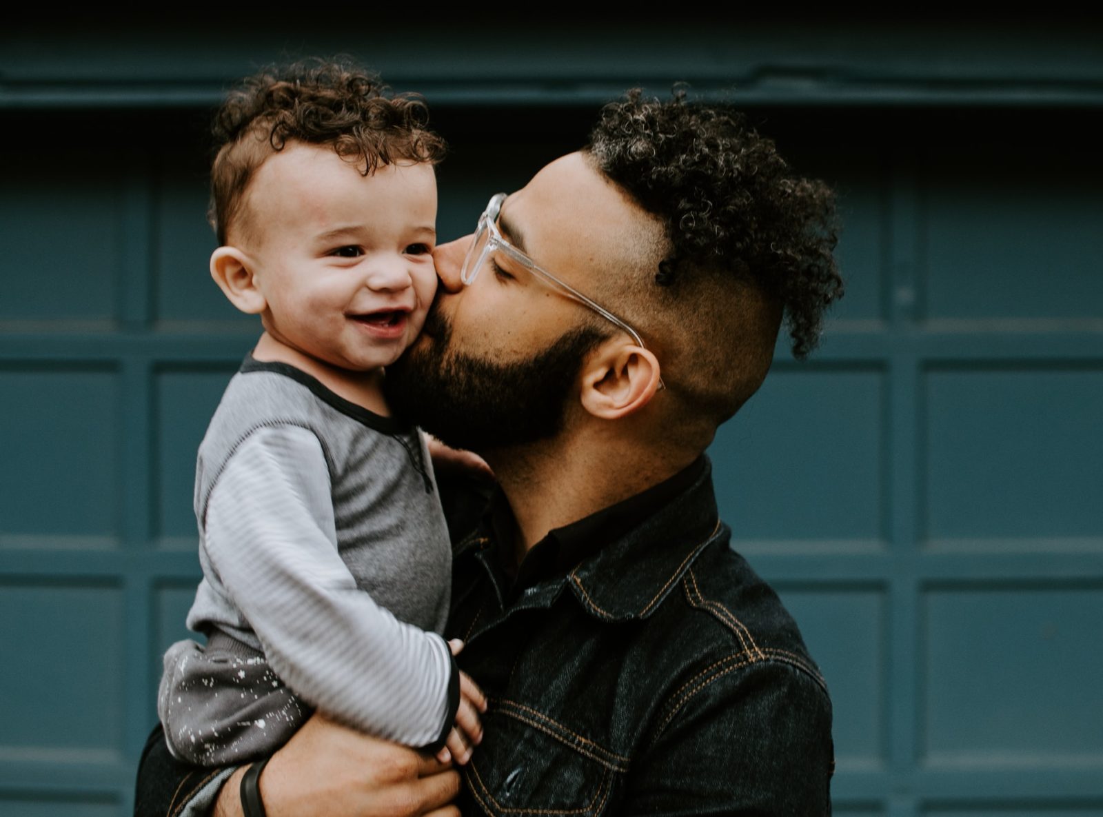 dad kissing son's cheek