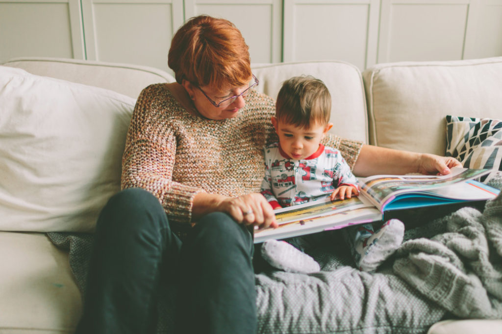 grandmother reading book to son