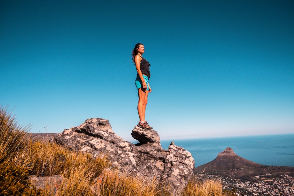 woman standing on a hiking rock