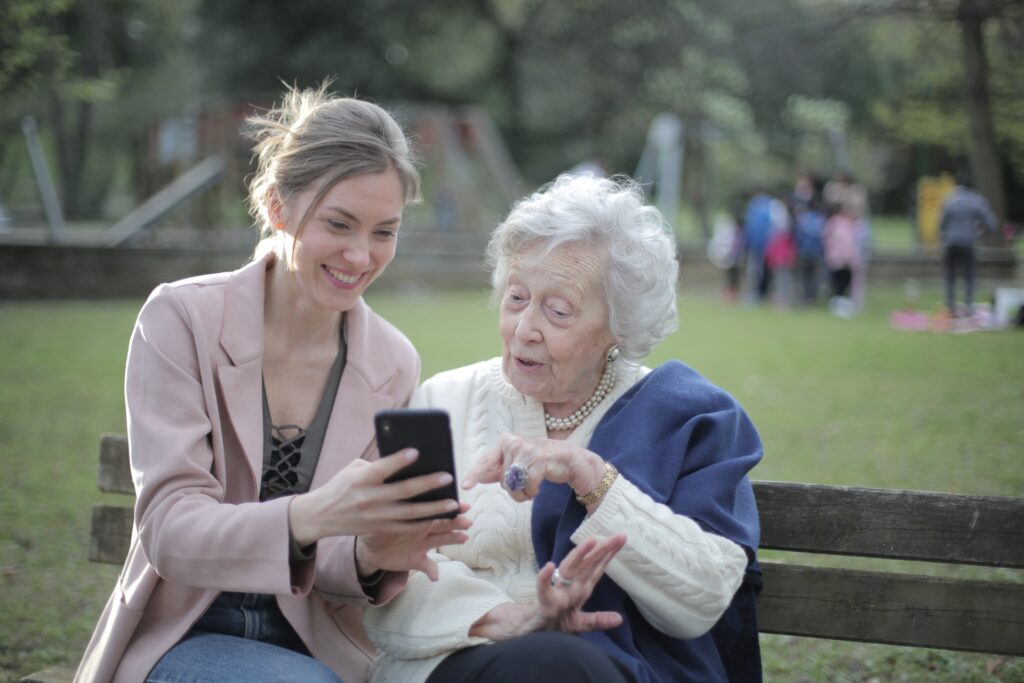 Older woman and younger woman sitting on a bench